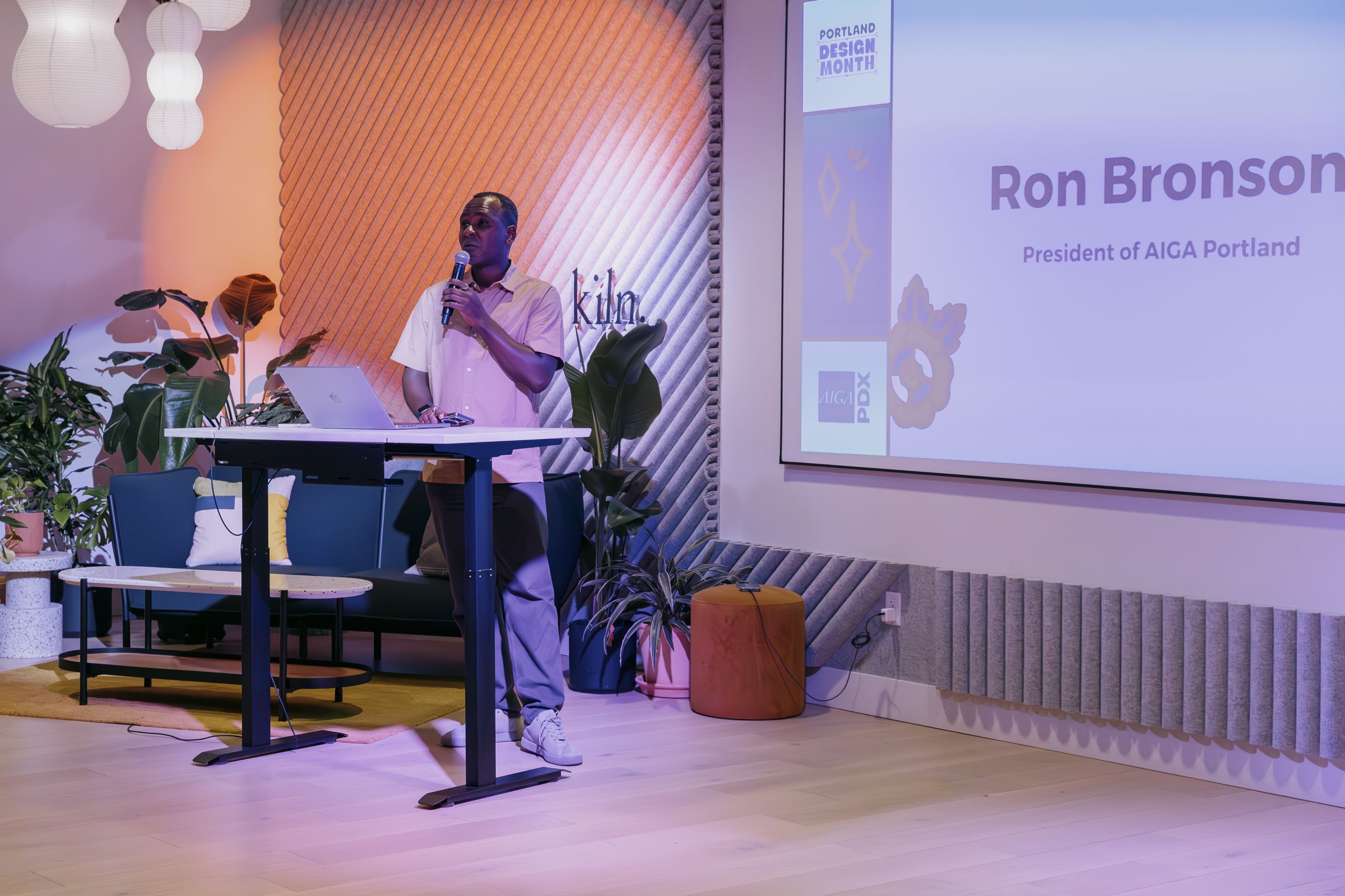 Ron Bronson speaking at a standing lectern during Portland Design Month